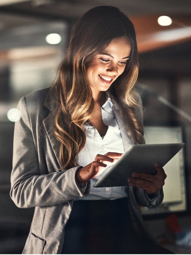 woman using an I-Pad to access an Embedded Analytics Portal